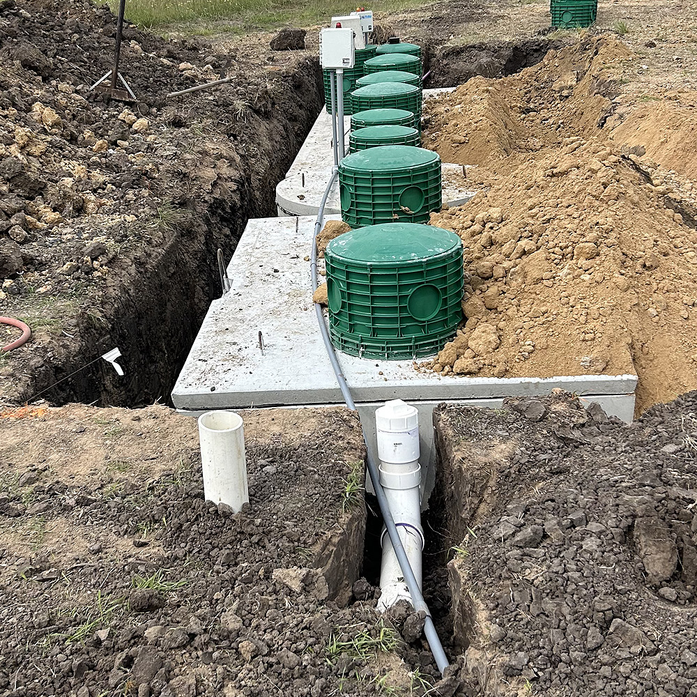 Professional septic subsurface operator in North Carolina conducting an efficiency check on a septic system