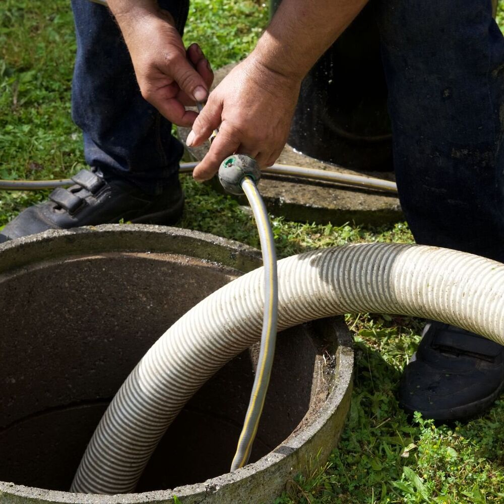 Expert Septic Innovations technician performing meticulous septic drain cleaning in a North Carolina home